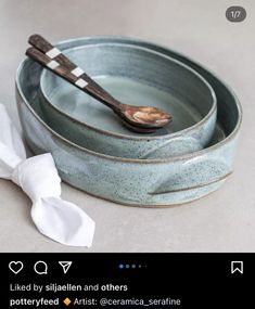 two bowls with spoons in them sitting on a table