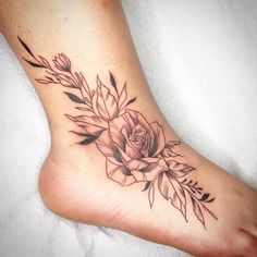 a black and white rose tattoo on the foot