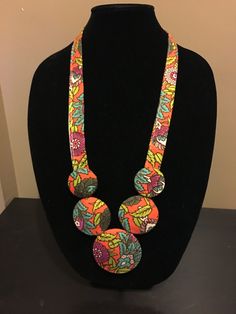 This is a handmade fabric necklace, made with a 70's funky floral fabric. I cut the fabric and wrap it around balsa wood pieces and some padding, sewing it together to make a unique statement necklace! The necklace is a good weight so it will stay put around your neck, and if you're looking for a necklace no one else will have, this is it! Could also make a fun gift for the accessory lovin' lady in your life who has it all! Please note this fabric is from a vintage piece of fabric! Bib Necklaces Statement, Diy Neckpiece, Fabric Jewellery Handmade, Fabric Necklace Diy, Fabric Flower Necklace, Fabric Bangles, Diy Fabric Jewellery, Unique Statement Necklace, Fabric Jewellery