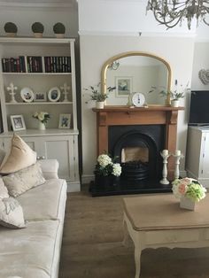 a living room filled with furniture and a fire place