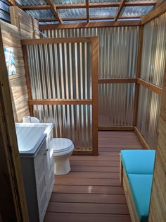 a small bathroom with wooden floors and walls