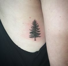 a small pine tree tattoo on the right side of her stomach