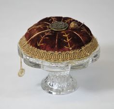 an old fashioned glass cake dish with gold trimmings on the top and bottom