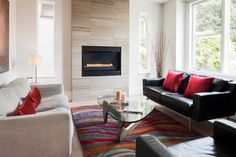 a living room filled with furniture and a fire place in the middle of the room