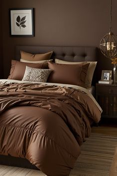 a bed with brown sheets and pillows in a bedroom