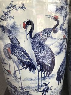 two blue and white vases with birds painted on them