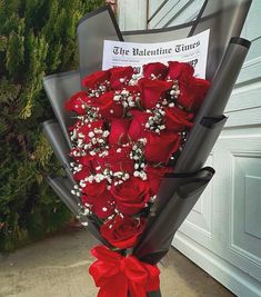 a bouquet of red roses wrapped in black paper