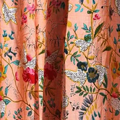 an orange curtain with floral designs on it