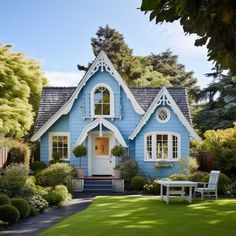 a blue house with white trim on the front door and windows is surrounded by greenery