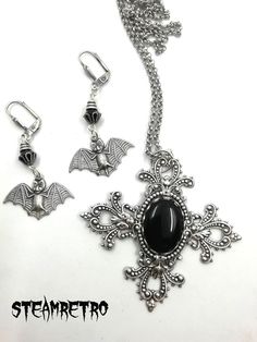 "This fantastic silver plated filigree cross necklace features a Swarovski black jet crystal and is part of our new Dark Gothic range, and is a step away from our previous steampunk work.The set comes complete with our spooky silver plated vampire bat earrings! There are numerous Gothic designers out there, and various marketplaces to purchase Gothic jewellery, but i am sure you will like what we are doing here Growing up in the 80's i lived through the \"goth\" movement, many a lost weekend was Halloween Gothic Pendant Jewelry, Silver Metal Witchy Jewelry, Silver Witchy Metal Jewelry, Gothic Pierced Jewelry For Wedding, Witchy Silver Metal Jewelry, Black Vampire Pendant Jewelry, Black Vampire Style Pendant Jewelry, Witchy Pierced Jewelry Gift, Silver Cross Jewelry For Halloween