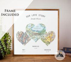 two heart shaped maps are displayed in front of a frame with the words our love story printed on it