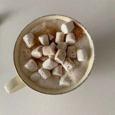 a cup filled with hot chocolate and marshmallows