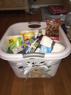 a white laundry basket filled with lots of items