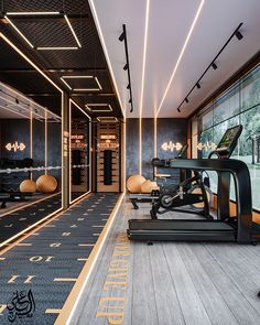 a gym with treadmills and exercise equipment in the center, along with large windows