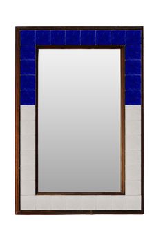 a bathroom mirror with blue and white tiles on the wall