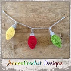 three crocheted hearts are hanging on a string with strings that have been made to look like leaves