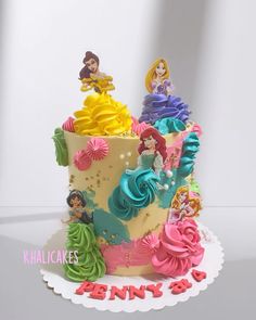 there is a birthday cake decorated with princesses on the top and bottom tiers