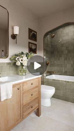 a bathroom with a sink, toilet and bathtub in the middle of it is shown