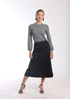 "Be right on clean minimal look with Aline midi skirt in timeless simplicity Black cotton skirt sits a little high on waist making your silhouette long and lean Midi length is super chic for this season Pair with simple top and heels or knee high boots to keep style minimal and polished Or wear as a chic casual skirt paired with snickers or athletic shoes -Tailored fit -Waist sits around naval -Side hidden zipper -Made of soft feel medium weighted cotton fabric with hint of stretch -Finishing is Solid Wrap Skirt For Work, Solid Color Wrap Skirt For Work, Relaxed Lined Maxi Skirt, Classic Relaxed Fit Lined Maxi Skirt, Fitted Wrap Skirt For Workwear, Classic Solid Maxi Skirt With Lining, Classic Solid Color Lined Maxi Skirt, Fitted Solid Color Wrap Skirt, Fitted Midi Pleated Skirt