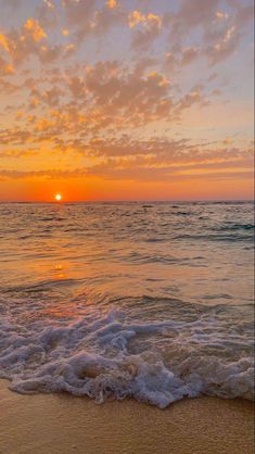 the sun is setting over the ocean with waves