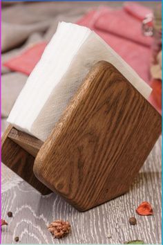 a napkin holder made out of wood and paper towels