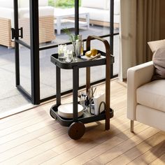 a living room with a couch, chair and coffee table in front of a sliding glass door