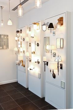 a row of white doors sitting next to each other on top of a tiled floor