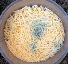 a bowl filled with cheese sitting on top of a counter