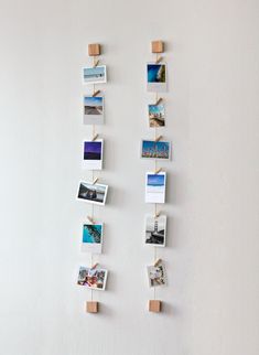 several pictures hanging on the wall with clothes pins attached to them and photos pinned to pegs