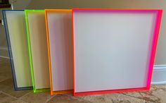 four different colored frames sitting on the floor