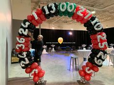 a man standing in front of a balloon arch