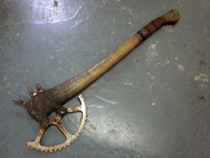 an old baseball bat laying on the ground next to a chainring sprocker