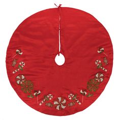 a red round christmas tree skirt with candy canes and candies on the front