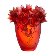 a red vase filled with lots of flowers