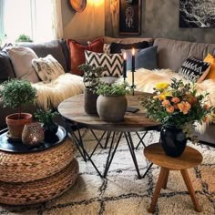 a living room filled with lots of furniture and flowers on top of a coffee table