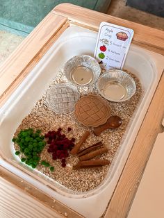 an assortment of food items displayed in a tray on top of a table with a sign