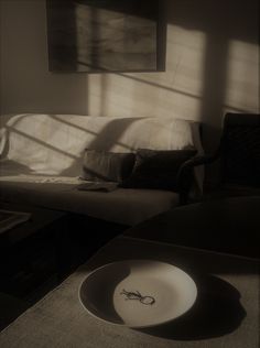 a white plate sitting on top of a table next to a couch