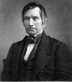 an old black and white photo of a man in a suit with a bow tie