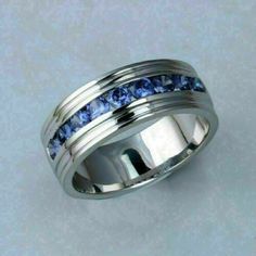 a white gold ring with blue sapphire stones