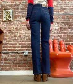 "70s Dark Wash Ultra High Waist Denim Straight Leg Jeans Beautiful seventies ultra high waist dark wash denim strait leg jeans. Orange top stitching. Fantastic detail on the back pockets. Zipper fly with a snap button closure at the waist. These are hot! In perfect condition. By Fort Dodge 26\" waist 31\" inseam 34\" hip 11\" rise in front 13.5\" rise in back 17\" circumference of hem Model is 5' 5\" 25\" waist 32\" hip Feel free to message me with any questions. I'm happy to help and quick to r Fitted Dark Wash Flare Jeans With Contrast Stitching, Fitted Dark Wash Pants With Contrast Stitching, Fitted Dark Wash Jeans With Contrast Stitching, High Rise Dark Wash Jeans With Contrast Stitching, Retro High Waist Jeans For Fall, Fitted Rigid Denim Flare Jeans In Dark Wash, Fitted Dark Wash Flare Jeans In Rigid Denim, Fitted Flare Jeans In Dark Wash Rigid Denim, Fitted Dark Wash Jeans With Belt Loops