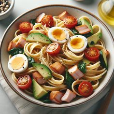 a bowl filled with pasta and vegetables on top of a table