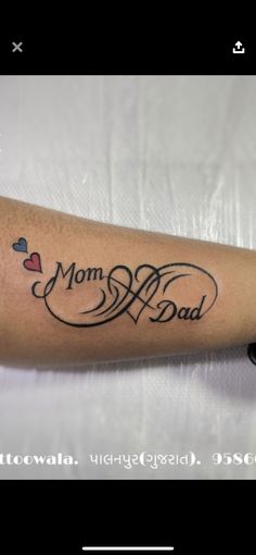 a woman with a tattoo on her arm that says, mom and dad in cursive writing