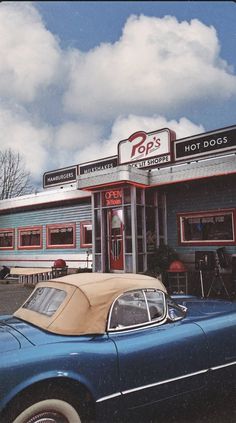 an old car is parked in front of a fast food restaurant with the words back at it