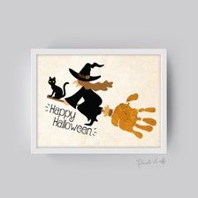 an image of a happy halloween card with handprints and a cat on it