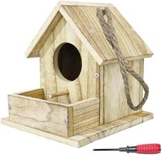 a wooden birdhouse with a cord attached to it