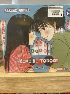 an image of a couple kissing on the cover of a book in a store shelf