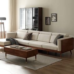 a living room with a couch, coffee table and bar stools in the corner