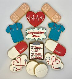 decorated cookies arranged in the shape of medical instruments and heart - shaped ones with words on them