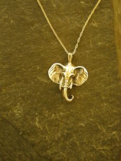 "This Elephant Head pendant is 14K Gold. The included chain is a 14K Gold chain. You may choose 16, 18 or 20 inch at the same price. Other length available at sightly higher prices. This Elephant Head pendant measures 1\" tall by 1 3/16\" across. I hand cast all my pieces using the lost wax casting method. Please ask your needs. You may call me with questions, often I am out so please use my machine. 831-476-3176. Satisfaction Guaranteed! I send items USPS First Class unless otherwise directed. Celtic Tree Of Life, Gold Elephant, Animal Pendant, Silver Wolf, Gold Pendant Jewelry, Elephant Head, Wax Casting, Lost Wax Casting, Pendant Gold