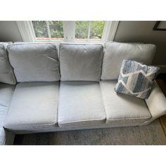 a white couch with two pillows on it